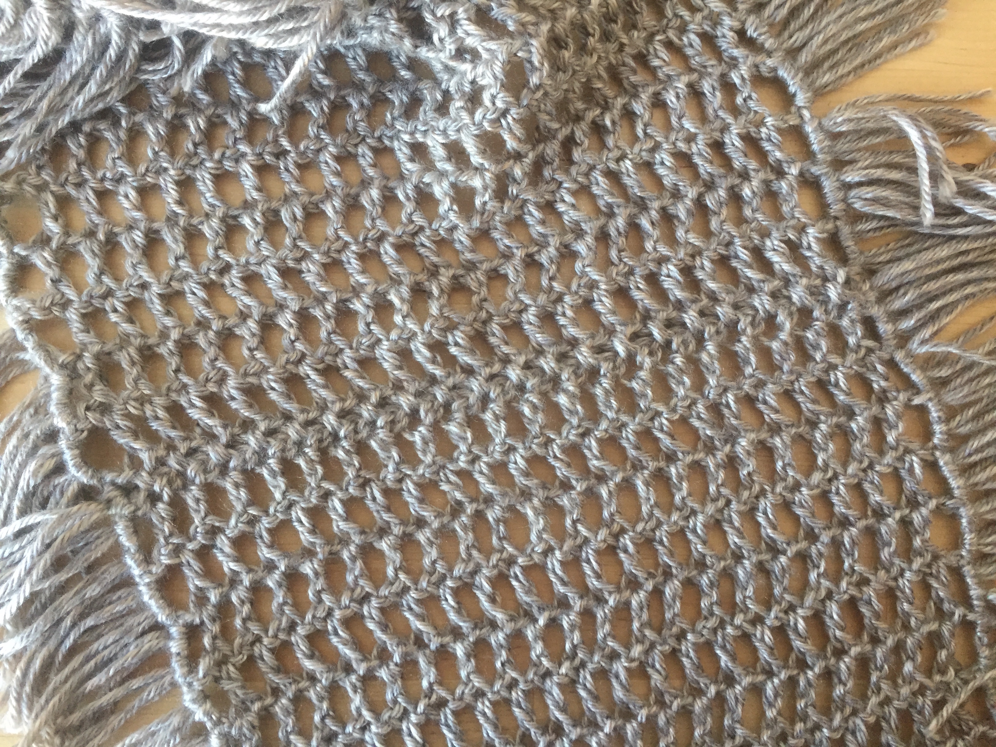 Photo of the seam of the fringed crochet mesh infinity scarf