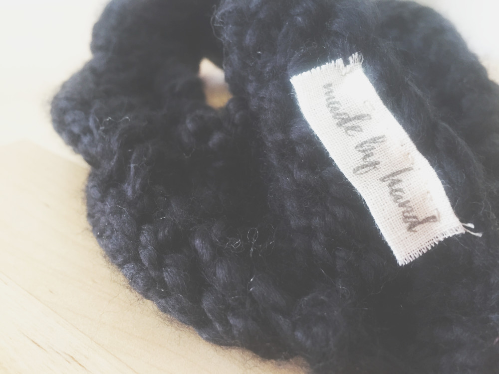 folded label attached to a cable knit headband